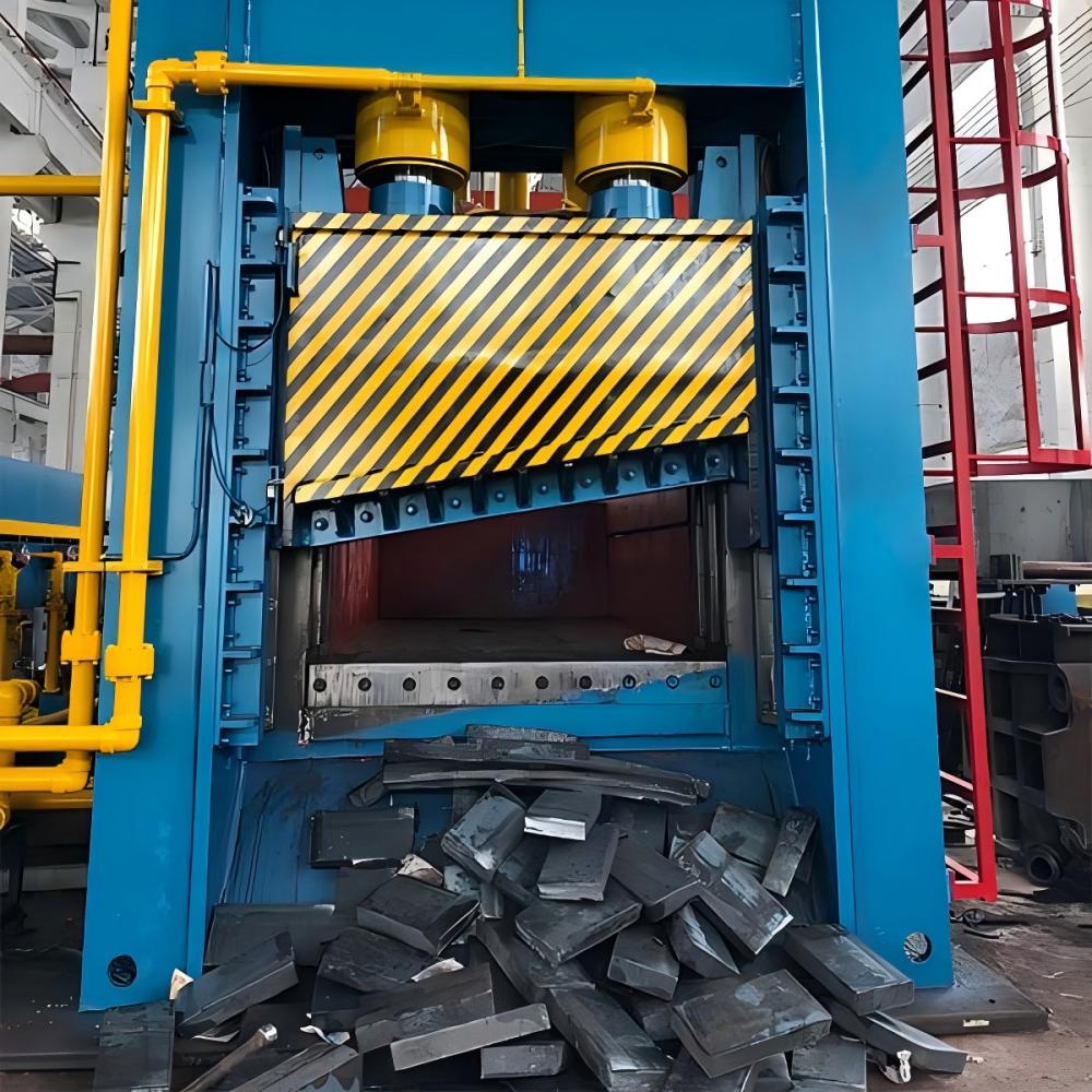 Industrial Scrap Metal Shear Baler and Logger in a recycling yard