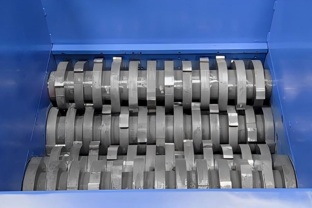 Industrial shredder processing various materials in a recycling facility