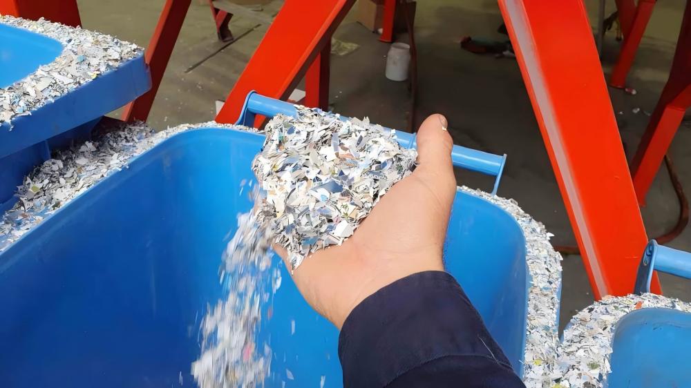 Technician performing maintenance on an industrial shredder